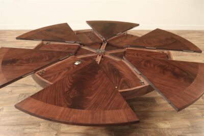 Large round mahogany dining table with self-storing leaves