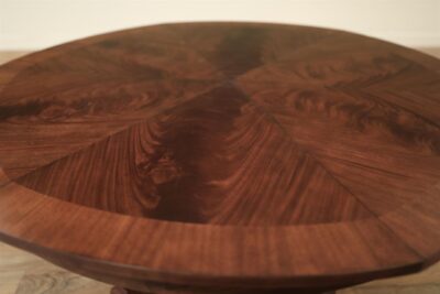 Inlaid mahogany border and pie-cut flame mahogany field