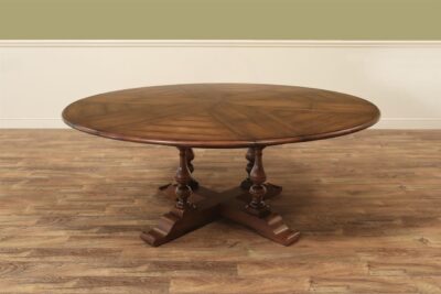 Alt Solid walnut dining table with maple color finish. Expands from 54-70 with self storing leaves.