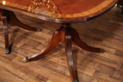 12 foot dining table on solid mahogany Duncan Phyfe pedestals