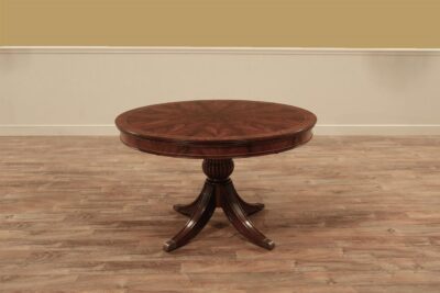 Small round to oval mahogany breakfast table with self-storing leaf