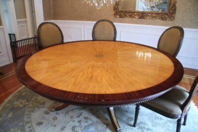 Finely crafted mahogany and satinwood 84 inch table. Striking color contrast and intricate inlays.