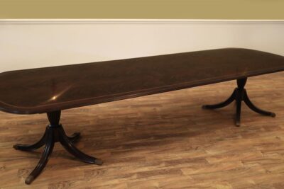 Dark mahogany dining table. 12 foot dining table with three leaves seats 14 people.