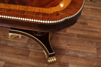 Gold leaf dining table with American Empire or Regency style pedestals