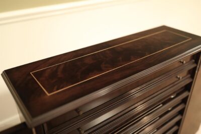 Top of cabinets are pinstriped and decorated with flame mahogany