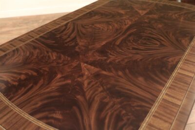 Sunburst flame mahogany table top with mutliple inlaid borders