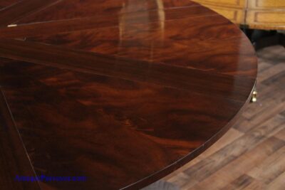 Swirl mahogany round dining table by Baker Furniture