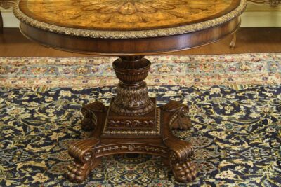 Mahogany and walnut inlaid empire style center table with gold accents