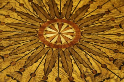 Pinwheel inlaid center table with acanthus leaf and bell flower inlays