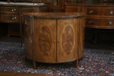 High end demilune chest with ribbon mahogany banding