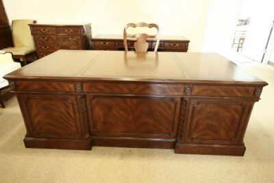 Large mahogany executive desk with detailed carving. File hangers for legal size folders.