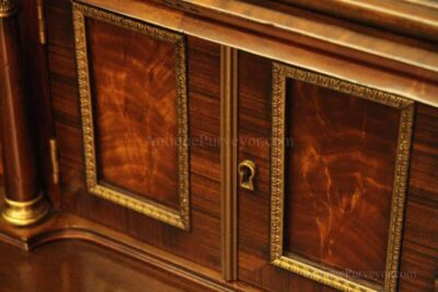 Brass astragals, key hardware and raised paneled doors with brass trim