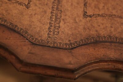 Embossed leather inset with gold tooling