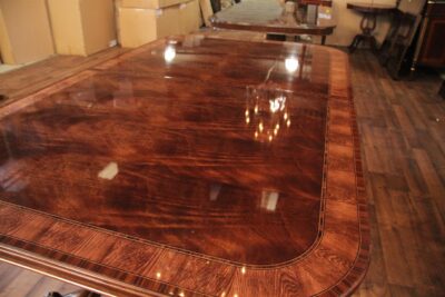 Expandable French Style mahogany dining table with blonde banding