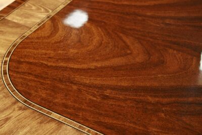 Close up of this reproduction antique mahogany conference table with blonde banding